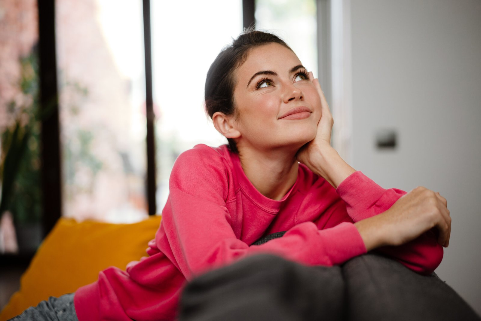 Dreamy attractive woman relaxing on a couch